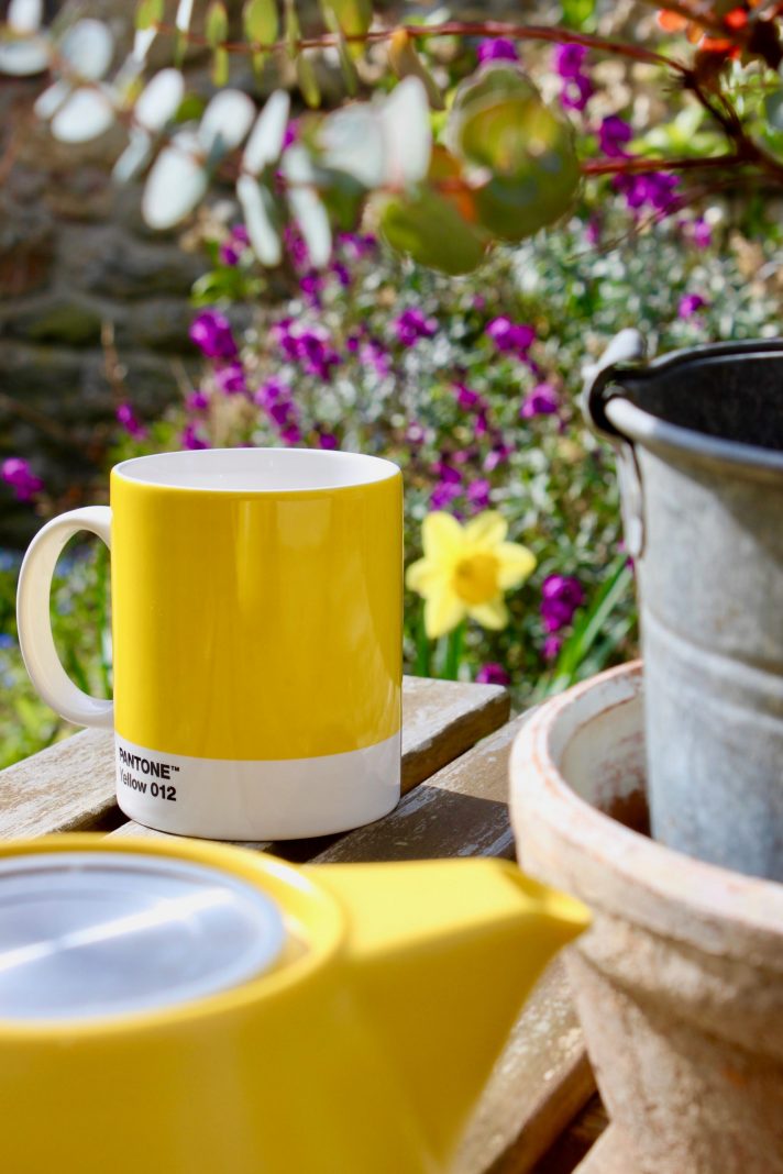 yellow ceramic mug on brown wooden table